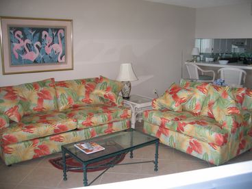 Great Room with Queen Sleeper Sofa and Love Sofa.  !8 inch Taupe colored Tile throughout the entire Condominium