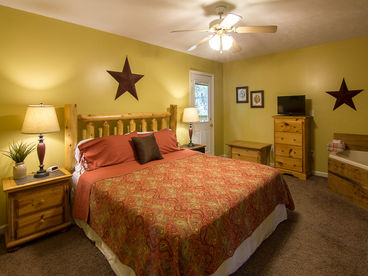 Master Bedroom with King Size Log Bed, Cable TV, Connecting Bath, and access to the Deck with Hot Tub