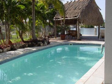 Pool overlooking tiki hut