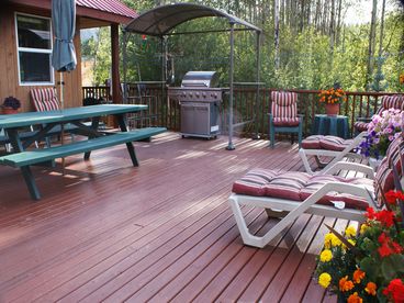 Large open deck overlooking lake with propane bar-bq and patio furniture.