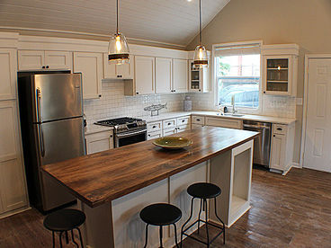 Full kitchen with gas range, stainless steel appliances and wine fridge