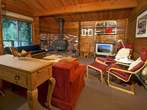 Warm up around the cozy grand wood stove. The living area has additional sleeping for 4 on the built in bed along the window and the new queen sleeper sofa.