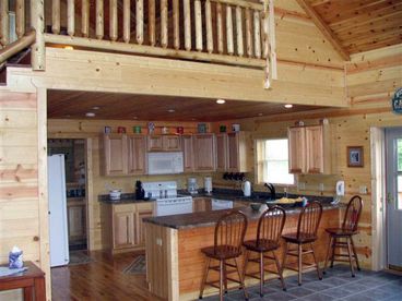 Full, open kitchen with barstools
