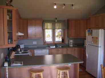 Looking into the fully equipped kitchen from the diningroom.