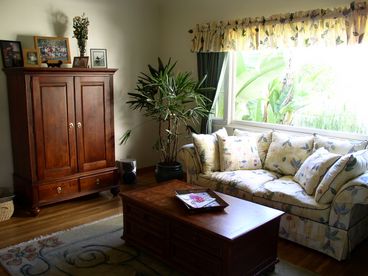 Comfy family room with entertainment center and views to outdoor courtyard.