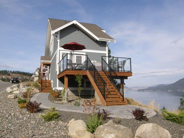 Landscaped lot with deck overlooking Lake Okanagan.