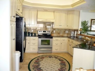 Fully-equipped kitchen with granite countertops & stainless steel appliances.