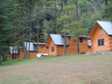 Outside picture of 5 log cabins
