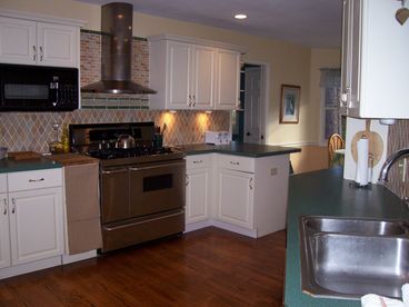 large open kitchen with updated appliances and dining areas that seat up to 12