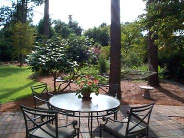 garden patio overlooking pond and hammock