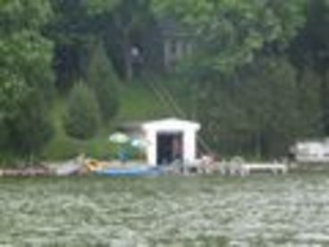 Picture of sand beach, boat house, kayak, canoes, pier, umbrellas, chairs all for your enjoyment. 