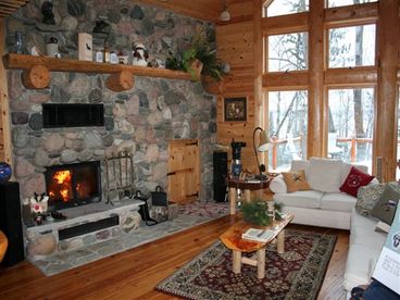 Natural fieldstone fireplace with wood storage