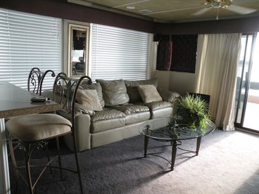 Living room has a leather sofa with pull out bed