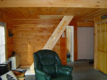 Living room with stairs leading up to the loft