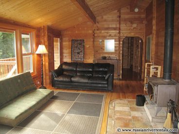 Wood gives instant warmth to the interior. Thanks to lots of windows the outside is never far off. The upstairs central room also serves as the main hub between the entrance, kitchen, upstairs bedrooms, decks and one of two bathrooms.