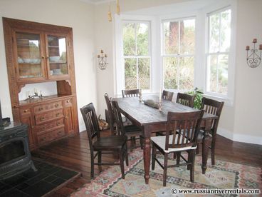 More bay windows and a cozy wood-burning stove grace the dining room. The built-in has unusual scroll-work designs that date from the turn of the century.