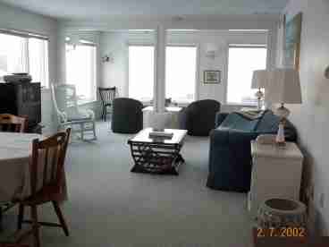 A view of the living room with the ocean in the background