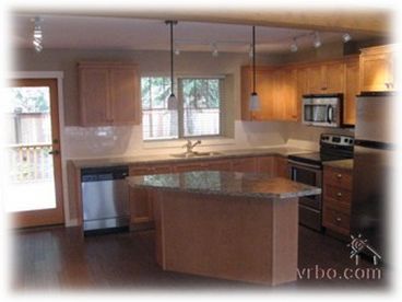 granite countertops and stainless steel appliances in the kitchen