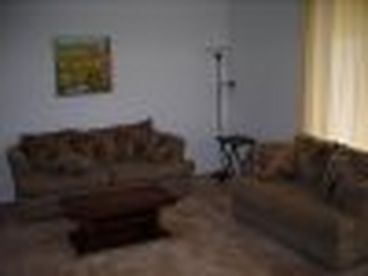 Living Room Overlooking Screened Lanai and Kitchen