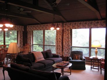 The Living Room features a Table that seats 8, an amazing view of Grandfather Mountain through floor to ceiling windows and a large fireplace.