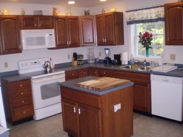Kitchen is fully equipped with appliances, accessories, and utensils. It includes a dishwasher, microwave, blender, toaster, and coffee maker. Spices and Lobster Pot included.
