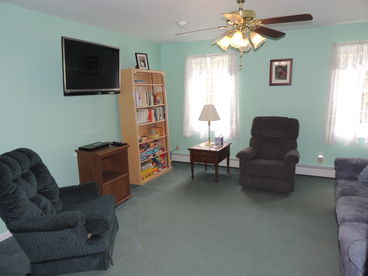 Has a large couch, 2 chairs, Large Flat Screen TV with Cable, DVD player with a selection of DVD\'s. Room also has books, games, and puzzles for Adults and children. Some toys available.