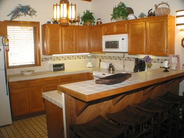 Fully-Equipped Kitchen w/ Range, Oven, Microwave, & Dishwasher. Laundry adjacent