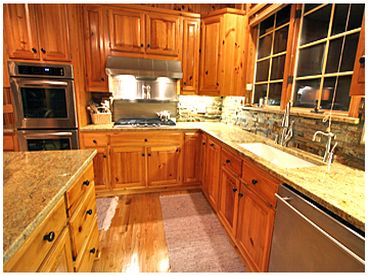 Kitchen w/granite counter tops and gourmet appliances incl subzero refrigerator, dbl ovens, gas stove top, pot filler, hot water dispenser and dishwasher