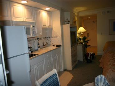 kitchenette with full fridge
cooktop stove