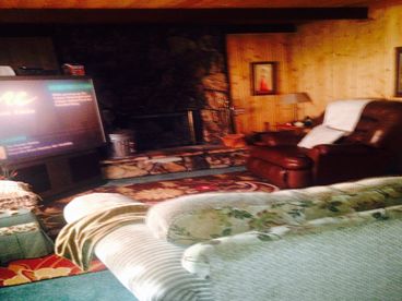 Living room w/50in color Tv & large fireplace & nice recliner & large sofa