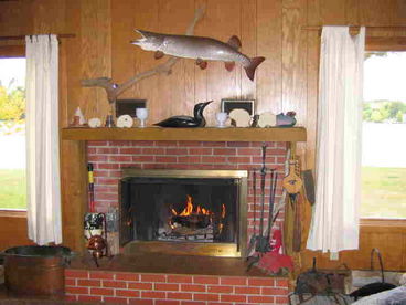 2 large windows on each side of the fireplace offer great lake view