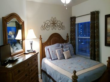 Queen bedroom with dresser, TV/DVD player and large closet.