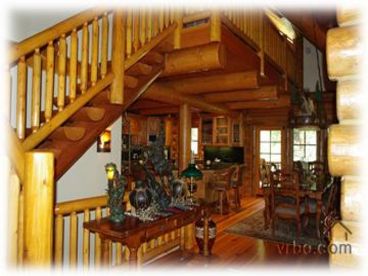 Magnificent log staircase to loft and huge log beam ceilings