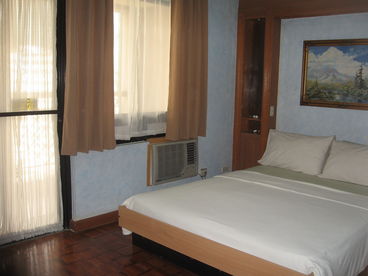 bedroom with airconditioner and balcony