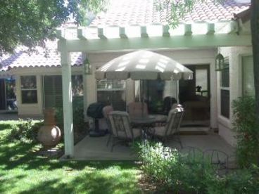 Patio with outdoor dining set and gas BBQ