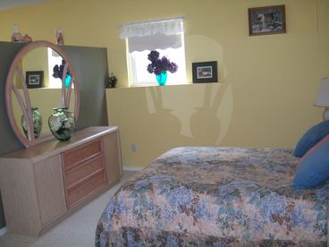 Open-style bedroom with queen bed