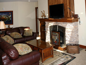 Elegant furnishings and quality features like stone hearth around Vermont Castings Gas Fireplace... large plasma TV