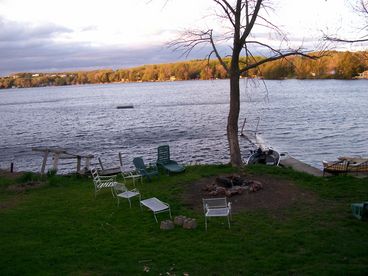 Front Yard with outdoor fire pit and boat dock.  Beach area is to the right of this photo.