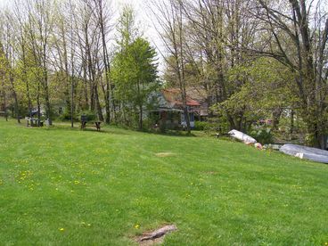 Side of home from beach area showing part of field next to home.