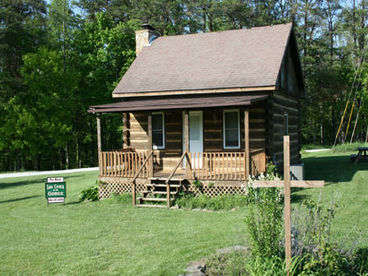 Front view of our authentic log cabin showing a very small portion of the large, all-around yard.