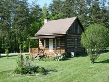 Our lovely cabin with a side view of the old time, traditional landscaping of the area.