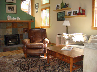 Sunken living room that includes a wood burning stove.