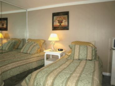 Twin bed room with private patio, bath, kitchenette.
