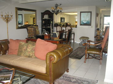 Elegant Living Area with plasma tv, fire place, porches and decks over loooking sparkling waters and outside dining.