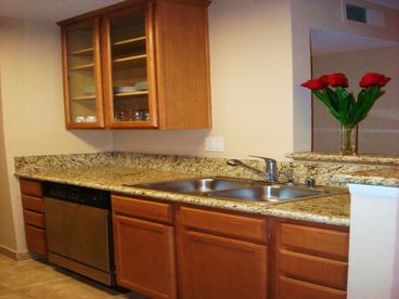 Granite countertops, stainless steel appliances, fully equipped with dishes, pans and cooking utensils.