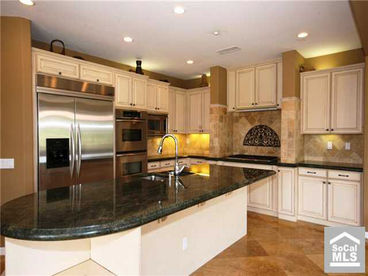 Gourmet Kitchen with:
Convection Oven 
Cooktop - Gas 
Double Oven
Freezer with Ice Maker
Garbage Disposal 
Laundry room with washer and dryer(downstairs)  
Microwave
Range Hood 
Refrigerator 
Self Cleaning Oven
Kitchen Island