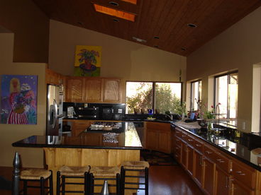 GOURMET KITCHEN LONG 12 FT GRANITE COUNTER ISLAND WALL OF WINDOWS TO TAKE IN THE VIEWS