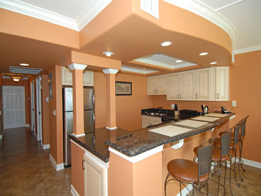 Granite countertops, stainless steel appliances, and countertop seating