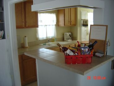 Fully equipped kitchen has non-coin washer/dryer, paper products and condiments.  Note gift basket on counter :-)