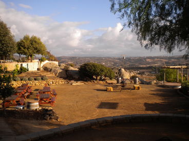 Large/lower back area has 8 picnic tables...firepit...arbor for ceremonies...and spectacular views!